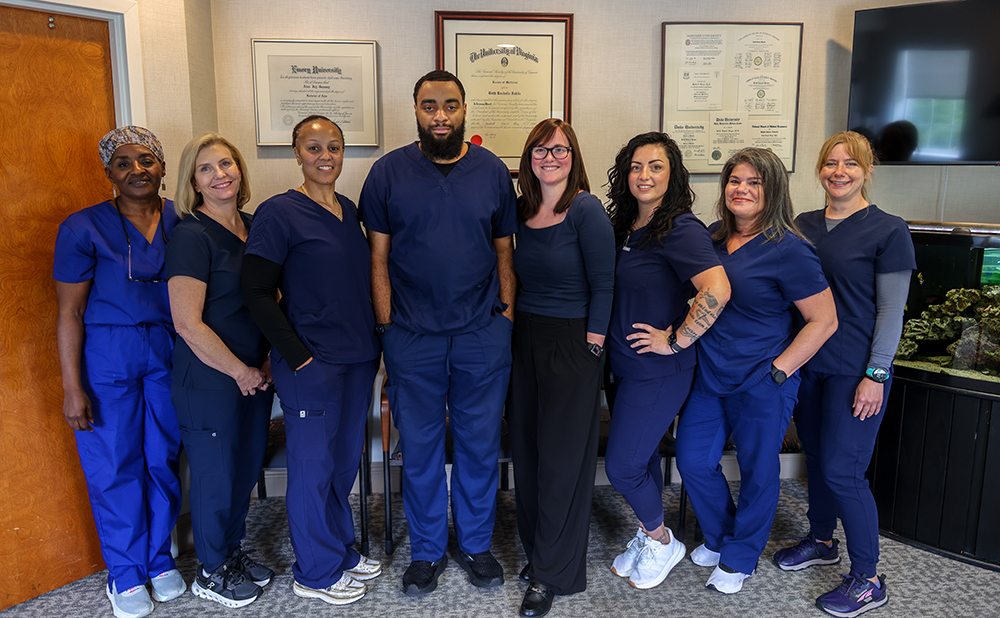 The staff at Virginia Colonoscopy posing for a group photo in the lobby of the practice.